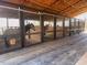 View of the multiple well-maintained stalls within the property's horse barn at 195 Falcon Ln, Rougemont, NC 27572