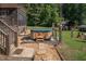 Soak in the backyard hot tub adjacent to the house and surrounded by mature trees at 195 Falcon Ln, Rougemont, NC 27572