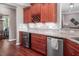 Cherry cabinetry, wine rack, granite counters, and stainless appliances make this kitchen a chef's dream at 195 Falcon Ln, Rougemont, NC 27572