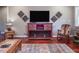 Cozy living room with flatscreen TV, decor, rocking chair, and wood floors at 195 Falcon Ln, Rougemont, NC 27572