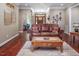 Well-lit living room with leather couch, wooden coffee table, and decor at 195 Falcon Ln, Rougemont, NC 27572