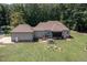 Back of home features a hot tub, screened in porch and patio furniture, perfect for outdoor relaxation and entertaining at 195 Falcon Ln, Rougemont, NC 27572