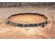 Aerial view of a roping pen featuring a tilled dirt ground and metal pipe surrounding it at 195 Falcon Ln, Rougemont, NC 27572