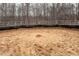 Outdoor view of a roping pen with tilled dirt and a length of rope in the center at 195 Falcon Ln, Rougemont, NC 27572