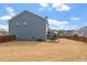 Large backyard with a privacy fence, grassy lawn, and outdoor seating area at 204 Cassada Ct, Holly Springs, NC 27540
