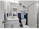 Well-lit bathroom featuring a modern vanity, a toilet, and a glass-enclosed shower for a clean and stylish look at 204 Cassada Ct, Holly Springs, NC 27540