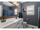 Modern bathroom featuring dual sinks, a framed mirror, and stylish fixtures at 204 Cassada Ct, Holly Springs, NC 27540
