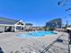 A community pool with a deck and ample space for lounging, next to neighborhood buildings at 204 Cassada Ct, Holly Springs, NC 27540