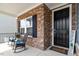 Inviting front porch with stone accents, seating, and a welcoming entrance to the home at 204 Cassada Ct, Holly Springs, NC 27540