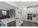 Modern kitchen featuring stainless steel appliances, granite countertops, and ample cabinet space at 204 Cassada Ct, Holly Springs, NC 27540