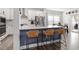 Eat-in kitchen featuring modern seating, stainless steel appliances, and a bright, airy atmosphere at 204 Cassada Ct, Holly Springs, NC 27540