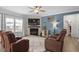 Spacious living room featuring a fireplace, large TV, and comfortable seating for entertainment at 204 Cassada Ct, Holly Springs, NC 27540