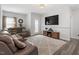 Cozy living room with a comfortable sofa, plush rug, and a mounted TV for entertainment at 204 Cassada Ct, Holly Springs, NC 27540