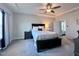 Serene main bedroom featuring a dark wood bed frame, soft lighting, and a glimpse into an attached bathroom at 204 Cassada Ct, Holly Springs, NC 27540
