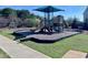 Community playground with a slide, climbing structure, and safety surfacing at 204 Cassada Ct, Holly Springs, NC 27540