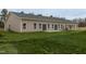 Rear exterior of the home showcasing the backyard and concrete patio at 210 Cason Dr, Gibsonville, NC 27249