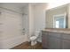 Bright bathroom featuring a tub and shower, toilet, and granite-topped vanity at 210 Cason Dr, Gibsonville, NC 27249
