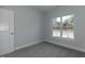Bedroom featuring a large window, plush carpet and neutral-colored walls at 210 Cason Dr, Gibsonville, NC 27249
