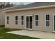 Back exterior view of home with a concrete patio and sliding glass doors at 210 Cason Dr, Gibsonville, NC 27249