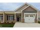 Charming home with brick and siding, an attached garage, and a welcoming entrance at 210 Cason Dr, Gibsonville, NC 27249