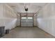 Spacious garage with painted drywall and a white paneled garage door with windows at 210 Cason Dr, Gibsonville, NC 27249