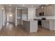 Open-concept kitchen with a center island, granite countertops, stainless appliances, and ample cabinet space at 210 Cason Dr, Gibsonville, NC 27249