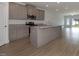 Modern kitchen with a large island, granite countertops, stainless steel appliances and wood grain floors at 210 Cason Dr, Gibsonville, NC 27249