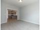 Carpeted living room with neutral paint and a view of the kitchen at 210 Cason Dr, Gibsonville, NC 27249
