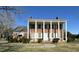 Elegant brick home boasts large white columns and shutters, enhancing its traditional charm at 2200 N Nc 49 Hwy, Burlington, NC 27217