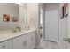 Bright bathroom offers a modern vanity with white countertop, framed mirror, and tile flooring at 228 Sacred Fire Rd, Louisburg, NC 27549