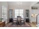 Bright dining room featuring a chandelier, modern furnishings, large windows, and wood floors at 228 Sacred Fire Rd, Louisburg, NC 27549