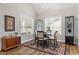 Inviting dining area with wood floors, natural light, modern chandelier, and display cabinets at 228 Sacred Fire Rd, Louisburg, NC 27549