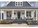 Inviting front porch features seating, dark wood flooring, and decorative accents creating a cozy outdoor space at 228 Sacred Fire Rd, Louisburg, NC 27549