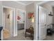 Hallway with two bedroom entries, a bathroom entry, and a side table with lamp and paintings at 228 Sacred Fire Rd, Louisburg, NC 27549