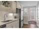 Bright kitchen showcasing granite countertops, stainless steel appliances, and an exterior door at 228 Sacred Fire Rd, Louisburg, NC 27549