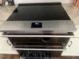 Modern kitchen appliance featuring a flat top cook surface and stainless steel exterior at 228 Sacred Fire Rd, Louisburg, NC 27549