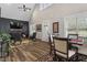 Open-concept design featuring wood floors, living area, dining space, high ceilings, and natural light at 228 Sacred Fire Rd, Louisburg, NC 27549