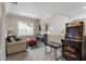 Upstairs living room offers lots of sunlight, comfortable seating, and fun-filled with a vintage arcade game at 228 Sacred Fire Rd, Louisburg, NC 27549