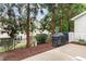 Backyard area with a grill, fenced perimeter, and patio, surrounded by mature trees and landscaping at 2314 Wispy Green Ln, Raleigh, NC 27614