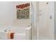Bright bathroom featuring a soaking tub and glass-enclosed shower with decorative stained-glass window at 2314 Wispy Green Ln, Raleigh, NC 27614