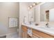 Bright bathroom featuring a double vanity with storage and neutral countertops and light fixtures at 2314 Wispy Green Ln, Raleigh, NC 27614
