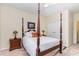 Spacious bedroom with a four poster bed, traditional lamps, and wall art on neutral walls at 2314 Wispy Green Ln, Raleigh, NC 27614
