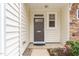 Inviting entryway featuring a neutral-toned door, stone accents, and manicured landscaping for a welcoming appeal at 2314 Wispy Green Ln, Raleigh, NC 27614