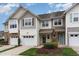 Attractive townhome featuring two-car garage, varied siding, and well-manicured landscaping at 2314 Wispy Green Ln, Raleigh, NC 27614
