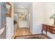 Welcoming foyer featuring hardwood floors, wainscoting, and an arched doorway, creating a warm and inviting space at 2314 Wispy Green Ln, Raleigh, NC 27614