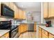 Well-lit kitchen featuring stainless steel appliances, granite countertops, and ample cabinetry at 2314 Wispy Green Ln, Raleigh, NC 27614