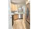 Bright kitchen boasts stainless steel appliances, granite countertops, and modern flooring at 2314 Wispy Green Ln, Raleigh, NC 27614