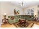 Comfortable living room featuring a ceiling fan, plush seating, and a decorative area rug at 2314 Wispy Green Ln, Raleigh, NC 27614