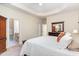 Cozy main bedroom features plush carpet, a tray ceiling, and a view of the en suite bathroom at 2314 Wispy Green Ln, Raleigh, NC 27614