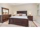 Spacious main bedroom showcases plush carpet, a tray ceiling, and elegant dark wood furniture at 2314 Wispy Green Ln, Raleigh, NC 27614